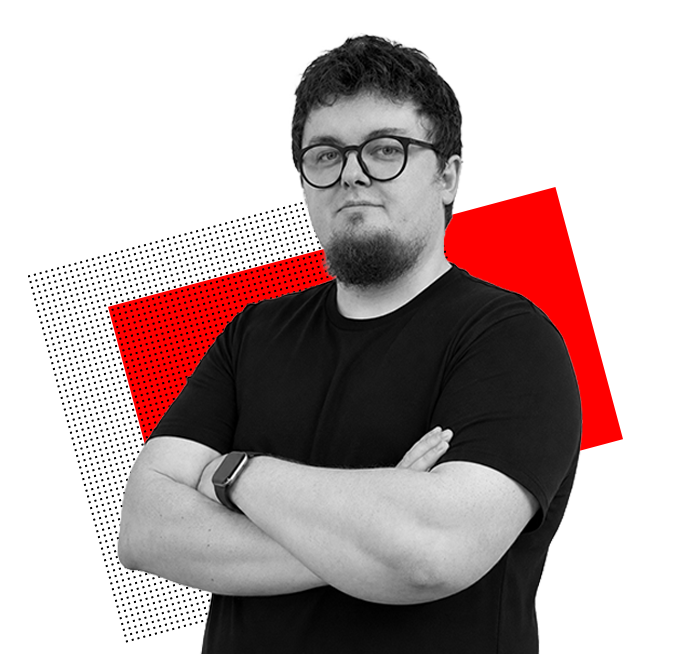 Portret mężczyzny w okularach i czarnym T-shircie, z rękami skrzyżowanymi na piersi, na tle czerwonego kształtu
